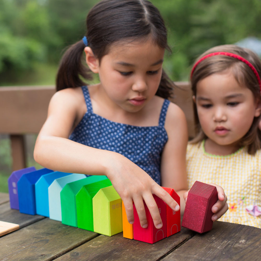 Two girls playing with Nova Natural building blocks.
